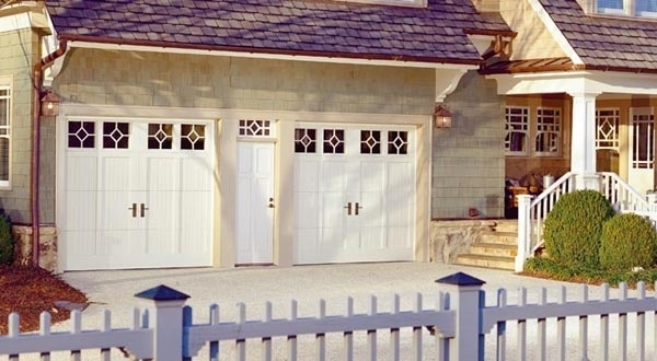 Double Amarr garage door in white with decorative trim and lights in San Jose, CA
