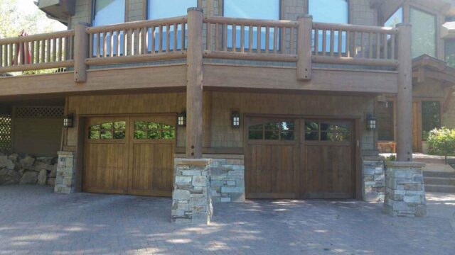 Elevated garage featuring carriage house door and wood accents in San Jose, CA